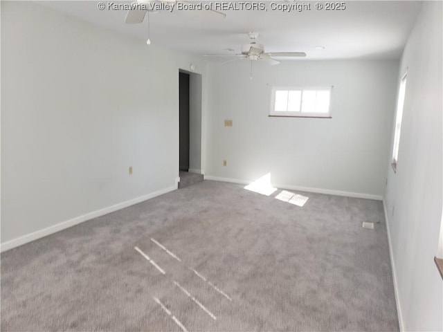 spare room with ceiling fan and carpet