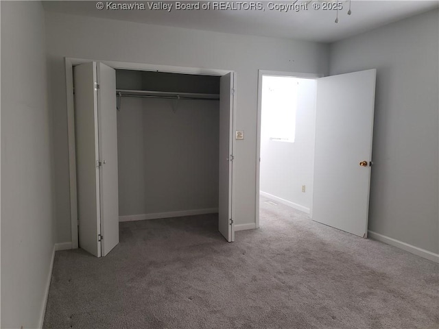 unfurnished bedroom with carpet floors and a closet