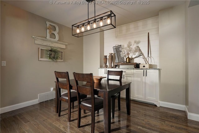 dining room with dark hardwood / wood-style floors