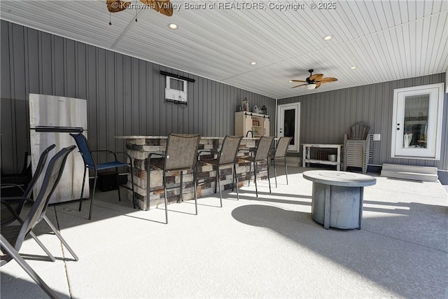 view of patio / terrace with a bar and ceiling fan