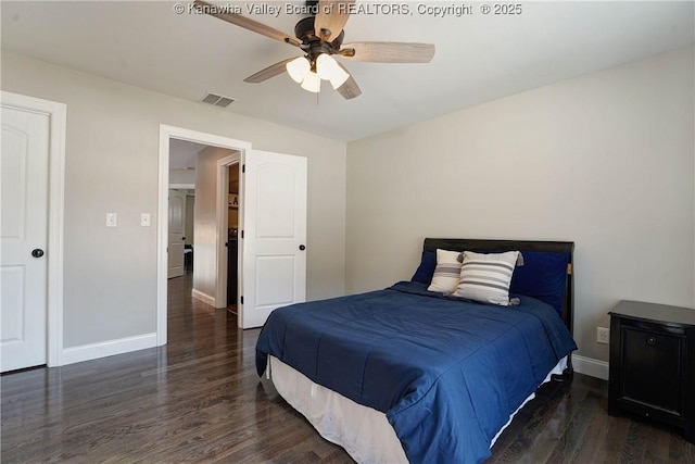 bedroom with dark hardwood / wood-style floors and ceiling fan