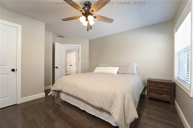 bedroom with dark wood-type flooring and ceiling fan