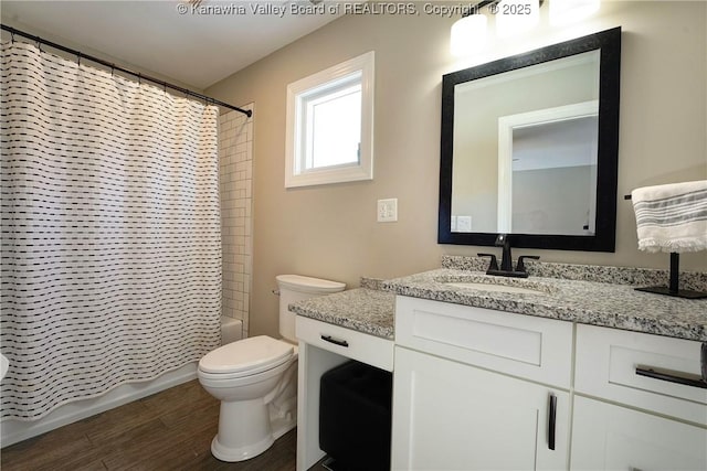 full bathroom with vanity, shower / tub combo, wood-type flooring, and toilet