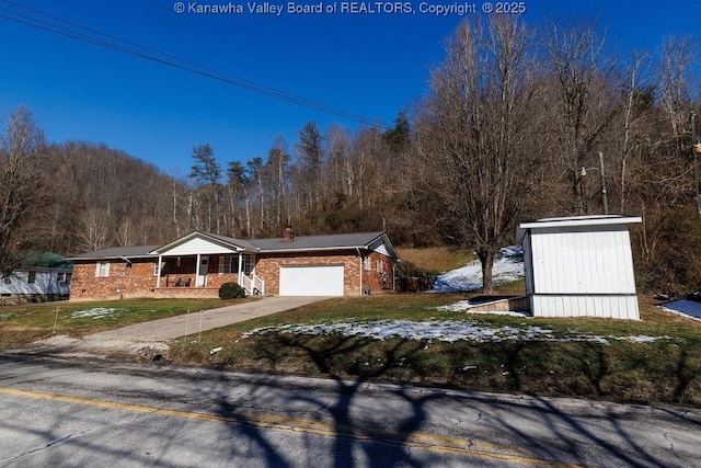 view of front of house with a garage, a porch, and a front yard