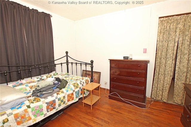 bedroom with hardwood / wood-style flooring