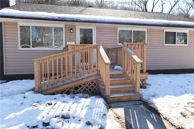 view of snow covered property entrance