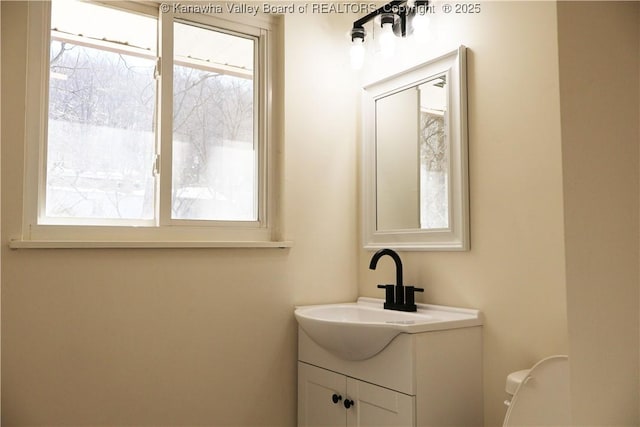 bathroom featuring vanity and toilet