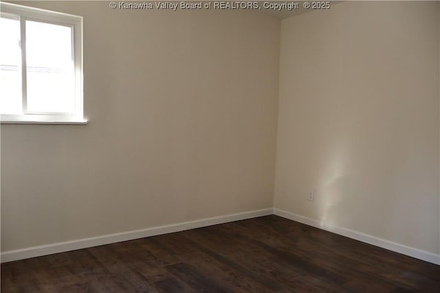 empty room with dark hardwood / wood-style flooring