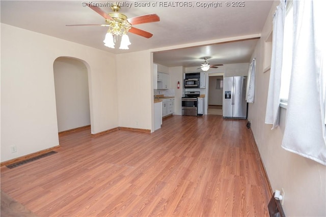 unfurnished living room with light hardwood / wood-style floors and ceiling fan