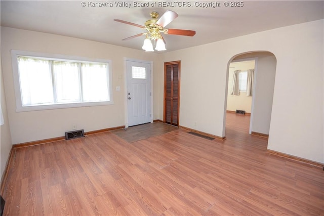 empty room with light hardwood / wood-style flooring and ceiling fan