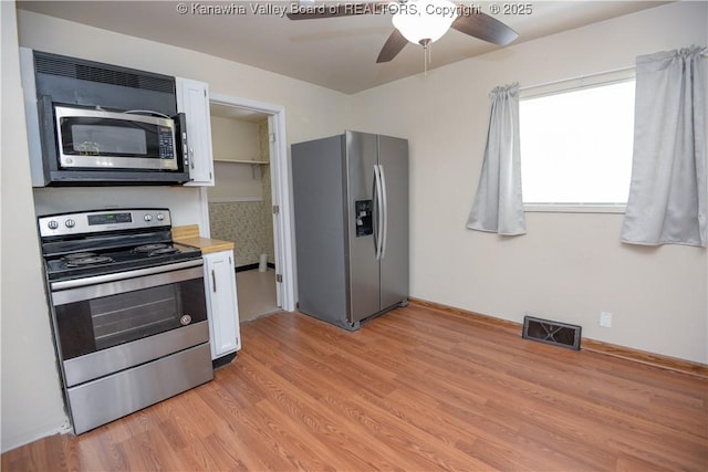 kitchen with white cabinetry, ceiling fan, appliances with stainless steel finishes, and light wood-type flooring