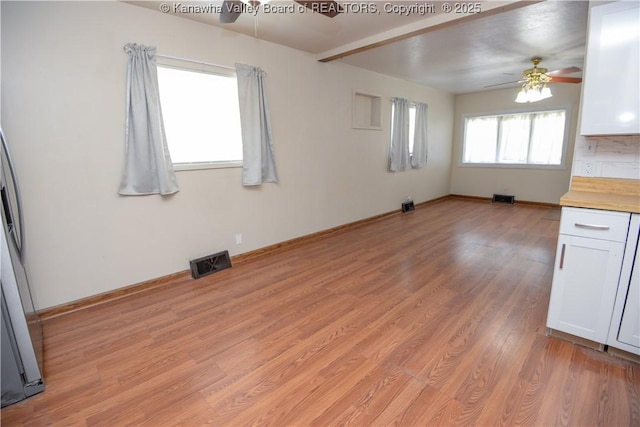 interior space with light wood-type flooring and ceiling fan