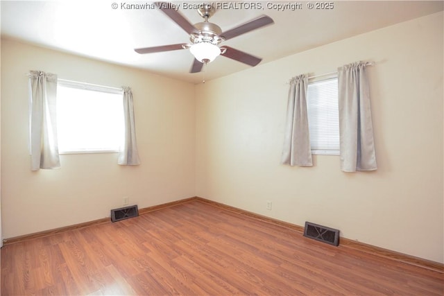 empty room featuring ceiling fan and hardwood / wood-style floors