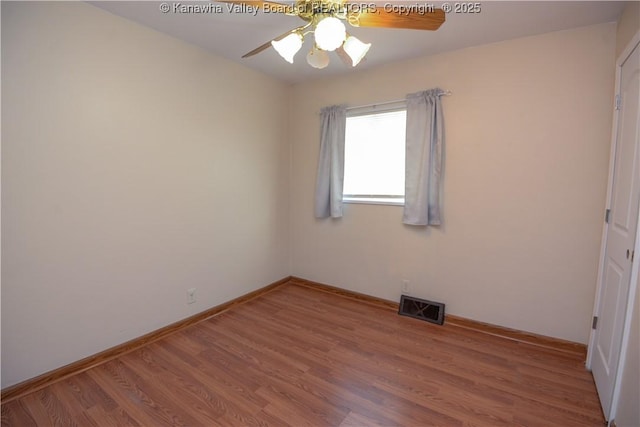 spare room with ceiling fan and hardwood / wood-style floors