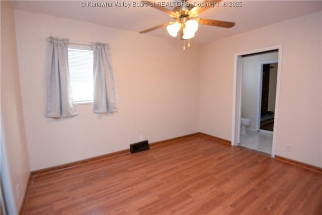 spare room featuring ceiling fan and wood-type flooring