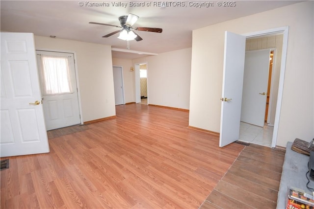 spare room with ceiling fan, plenty of natural light, and light wood-type flooring