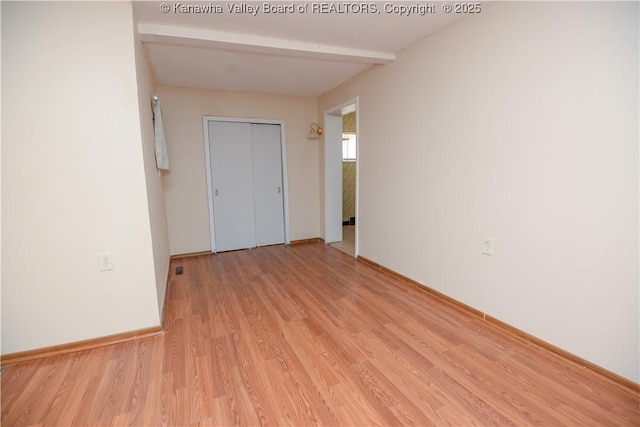 interior space with beam ceiling and light wood-type flooring