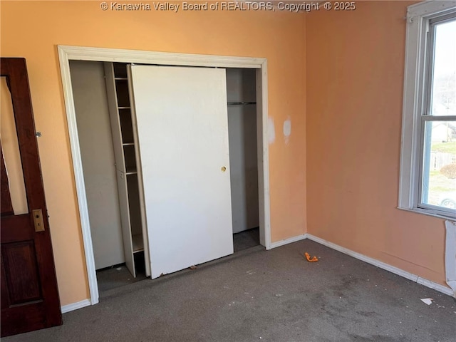 unfurnished bedroom with multiple windows and a closet