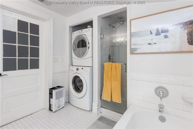 washroom with stacked washing maching and dryer