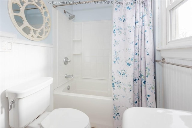 bathroom featuring shower / bath combo and toilet