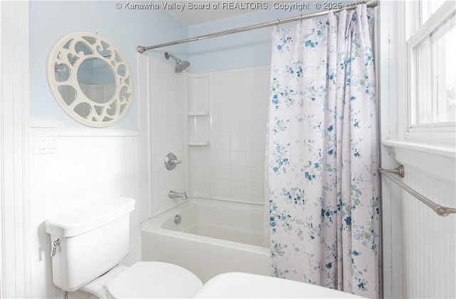 bathroom with shower / bath combination with curtain and toilet