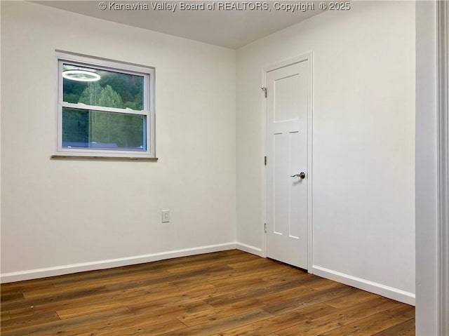 empty room with dark wood-type flooring