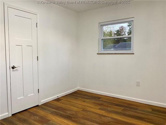 empty room with dark hardwood / wood-style floors