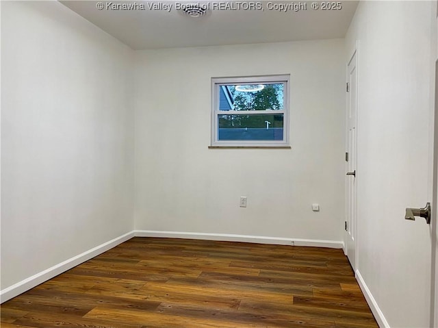 spare room with dark hardwood / wood-style floors