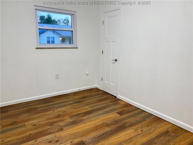 spare room with dark wood-type flooring