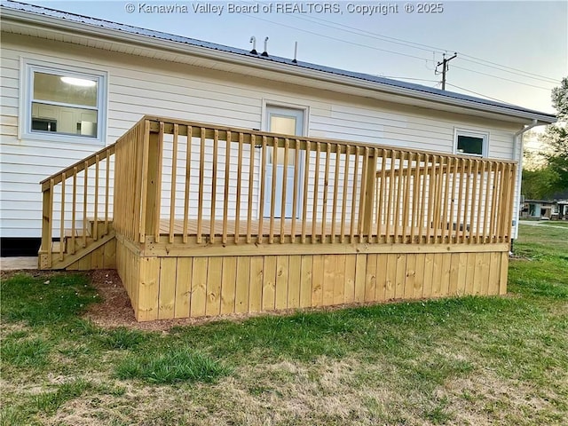 wooden deck with a lawn