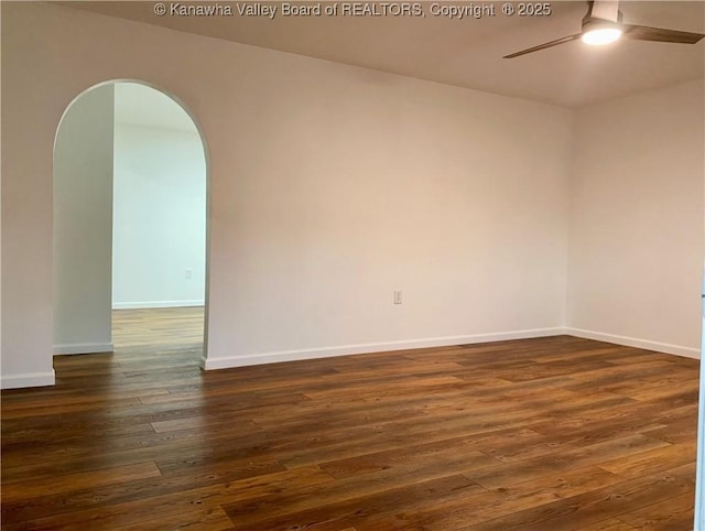 unfurnished room with dark hardwood / wood-style floors and ceiling fan