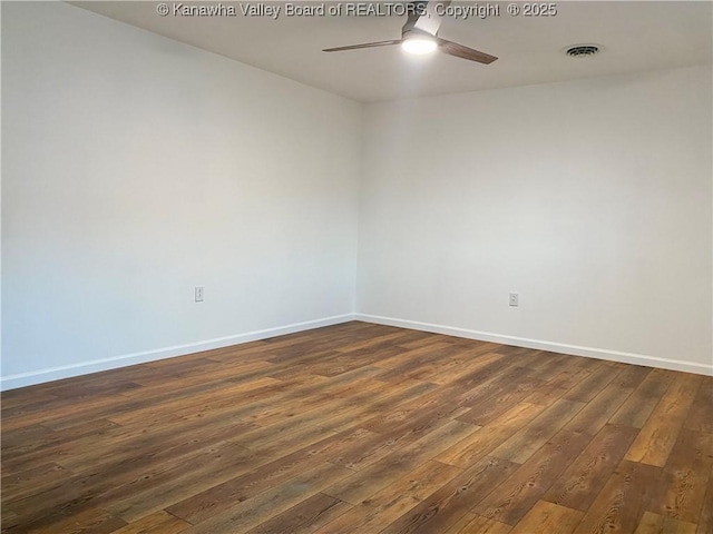 unfurnished room featuring dark wood-type flooring and ceiling fan