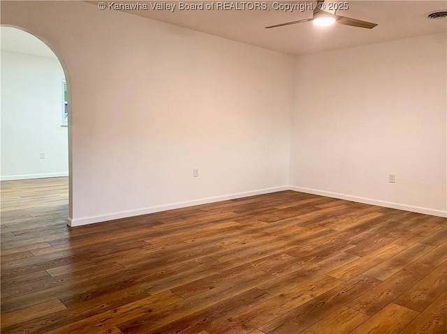 spare room featuring dark hardwood / wood-style flooring and ceiling fan