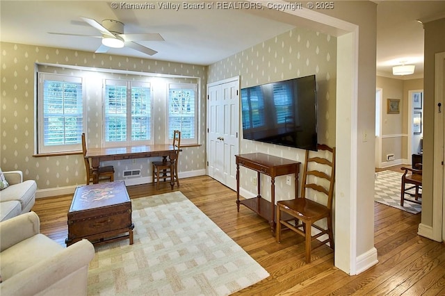 living room with hardwood / wood-style flooring and ceiling fan