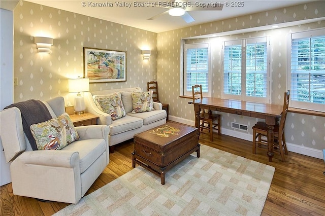 living room with hardwood / wood-style flooring and ceiling fan