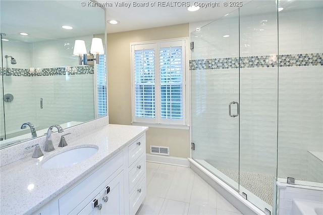 bathroom featuring a wealth of natural light, tile patterned floors, and walk in shower