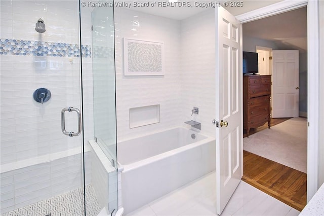 bathroom with tile patterned floors and shower with separate bathtub