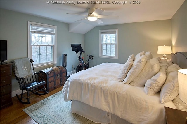 bedroom with multiple windows, wood-type flooring, lofted ceiling, and ceiling fan