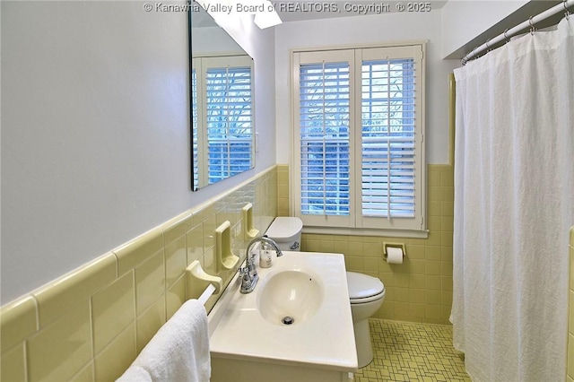 bathroom featuring vanity, tile walls, curtained shower, and toilet