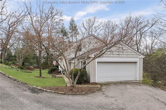 view of side of property with a garage and a lawn