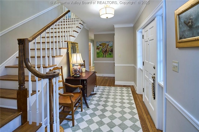 entrance foyer featuring crown molding and dark hardwood / wood-style flooring