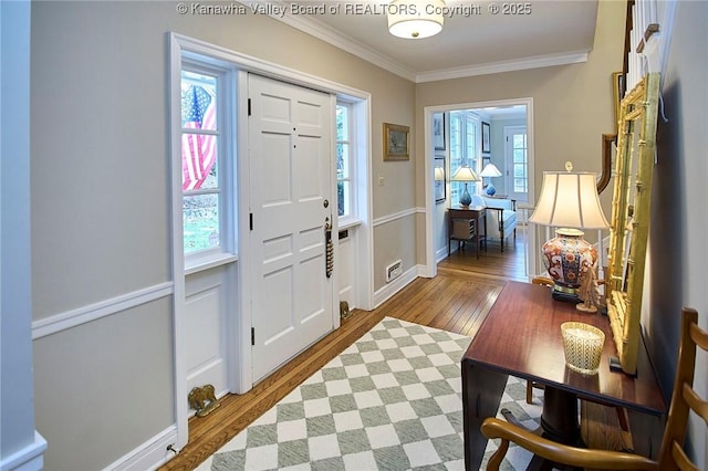 entryway with crown molding and wood-type flooring