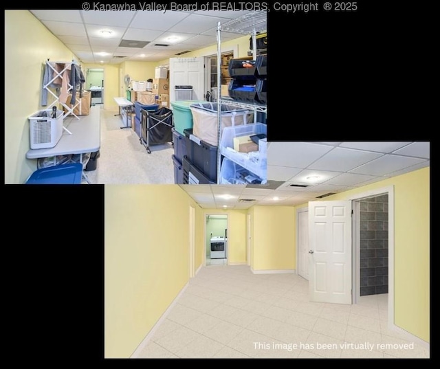 basement featuring a paneled ceiling and washer / clothes dryer