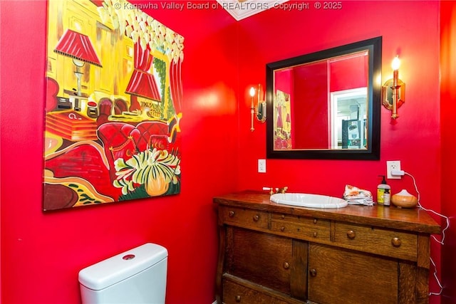 bathroom featuring vanity and toilet