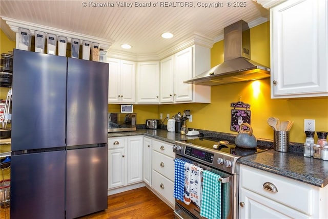 kitchen featuring white cabinetry, dark wood-type flooring, wall chimney exhaust hood, and appliances with stainless steel finishes