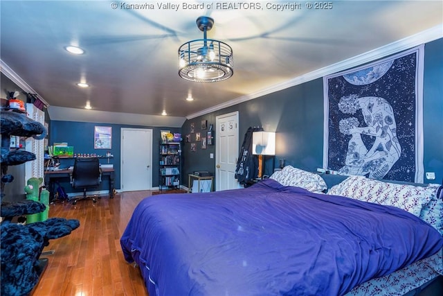 bedroom with hardwood / wood-style flooring and ornamental molding