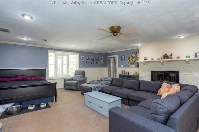 living room featuring crown molding, a fireplace, and light colored carpet