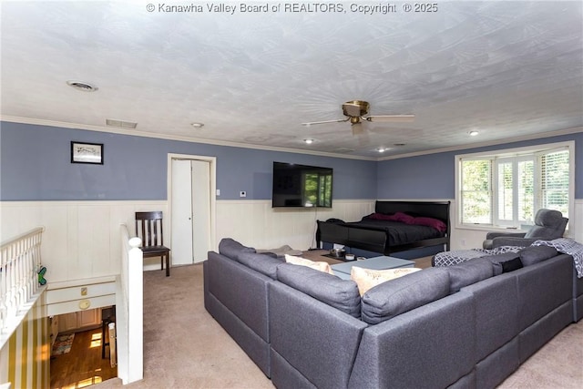 living room featuring crown molding, light colored carpet, and a textured ceiling