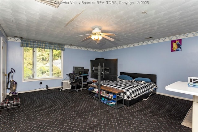 bedroom with carpet flooring, a textured ceiling, and ceiling fan