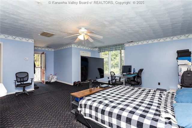 carpeted bedroom with a textured ceiling and ceiling fan